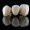 three beautiful dental crowns of natural color on black glass with reflection