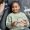 Portrait of black little girl in dental chair holding tooth model and smiling happily looking at female dentist, copy space